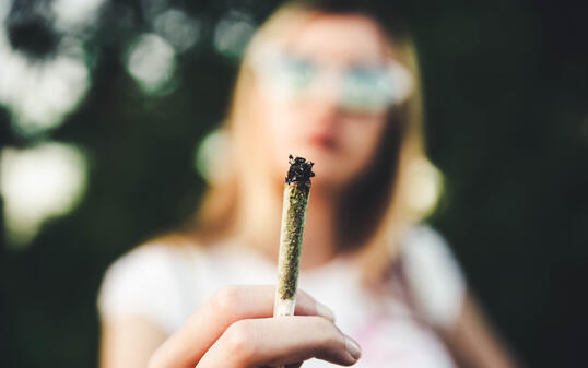 Woman holding marijuana joint