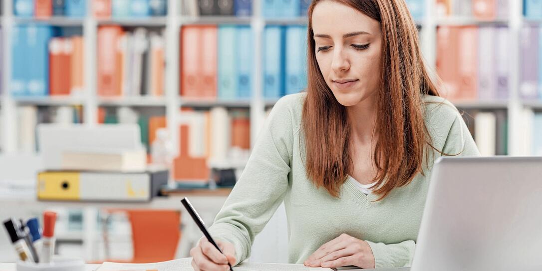 University student reading a textbook