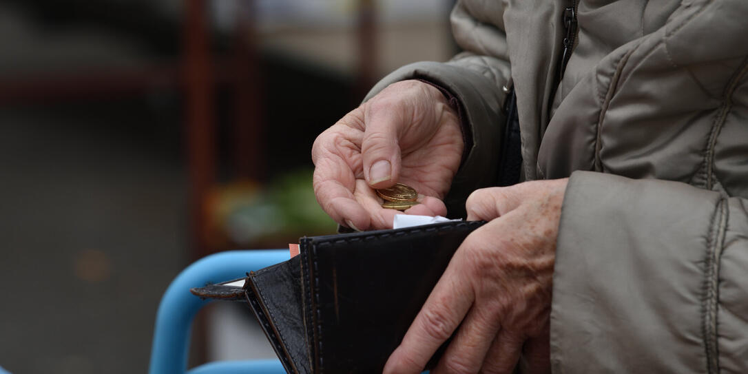 Close-up of paying  with euros.