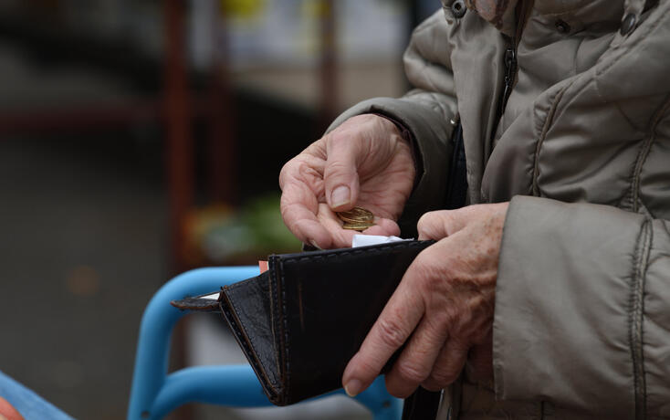 Close-up of paying  with euros.