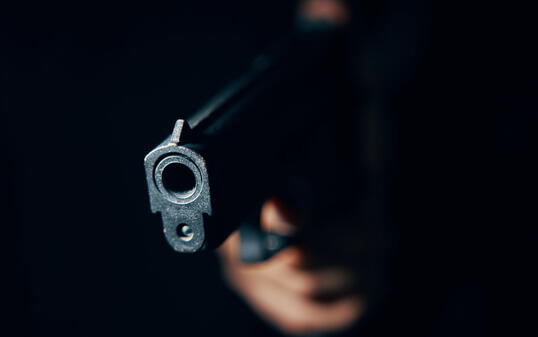 Close-up of black pistol in hand.