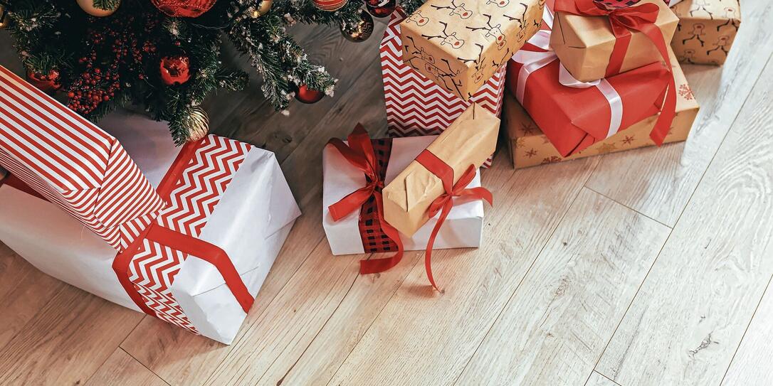 Multicolored gifts under the Christmas tree photo close-up New Year's Eve, multicolored gifts, red and gray and black