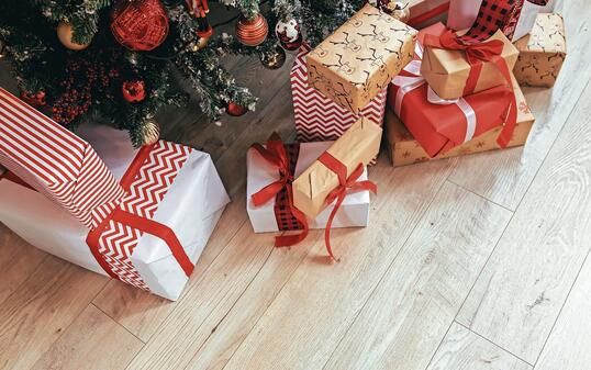 Multicolored gifts under the Christmas tree photo close-up New Year's Eve, multicolored gifts, red and gray and black
