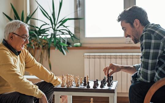 Happy men playing chess