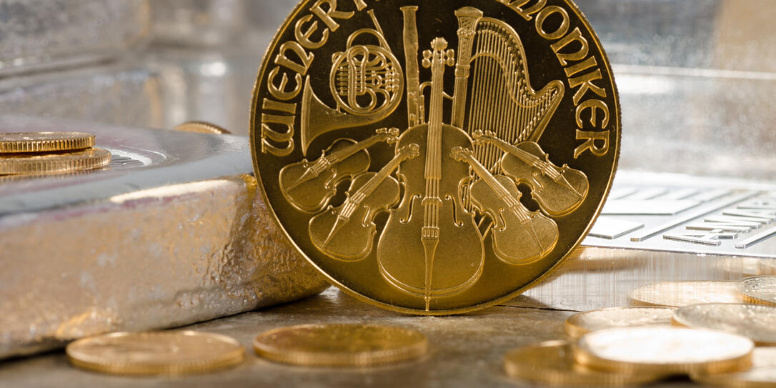 Austria Gold Philharmonic Coin with Silver Bars in Background Austria Gold Philharmonic Coin with Silver Bars in Background