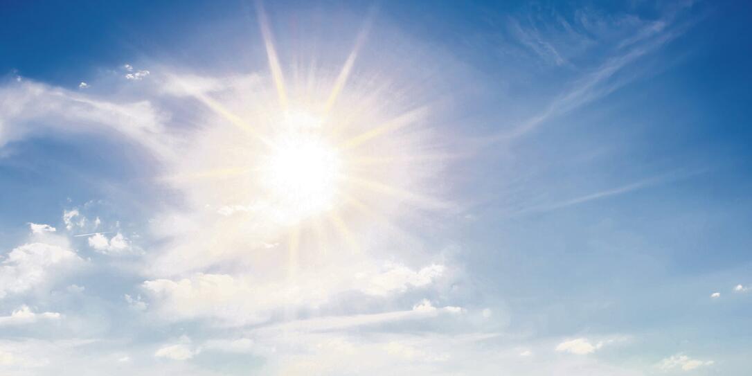 Blue sky with bright sun as background