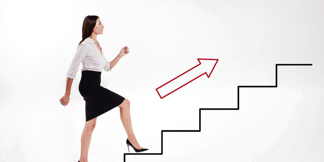 Young businesswoman walking up on stairs