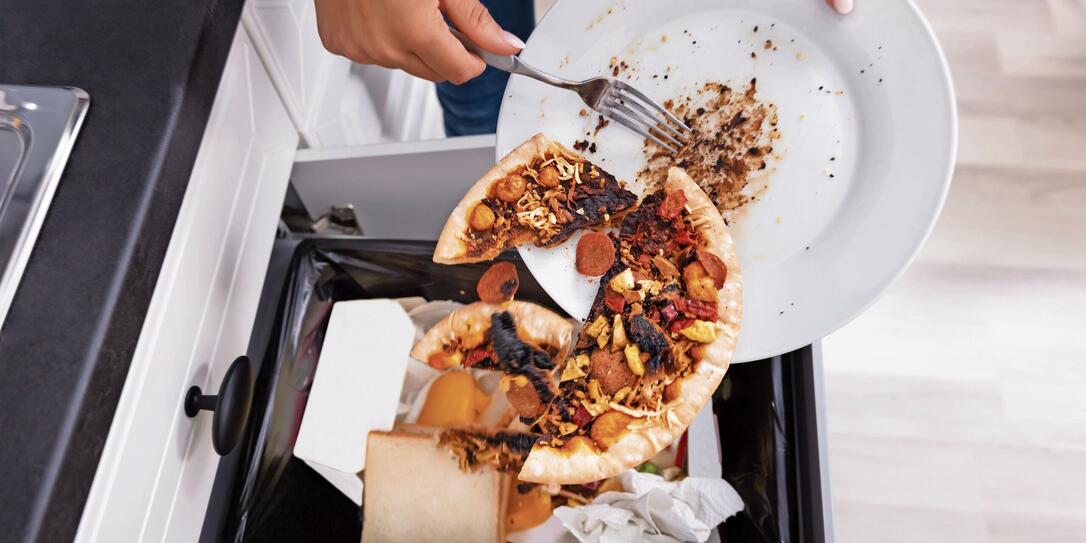 Person Throwing Pepperoni Pizza In Dustbin
