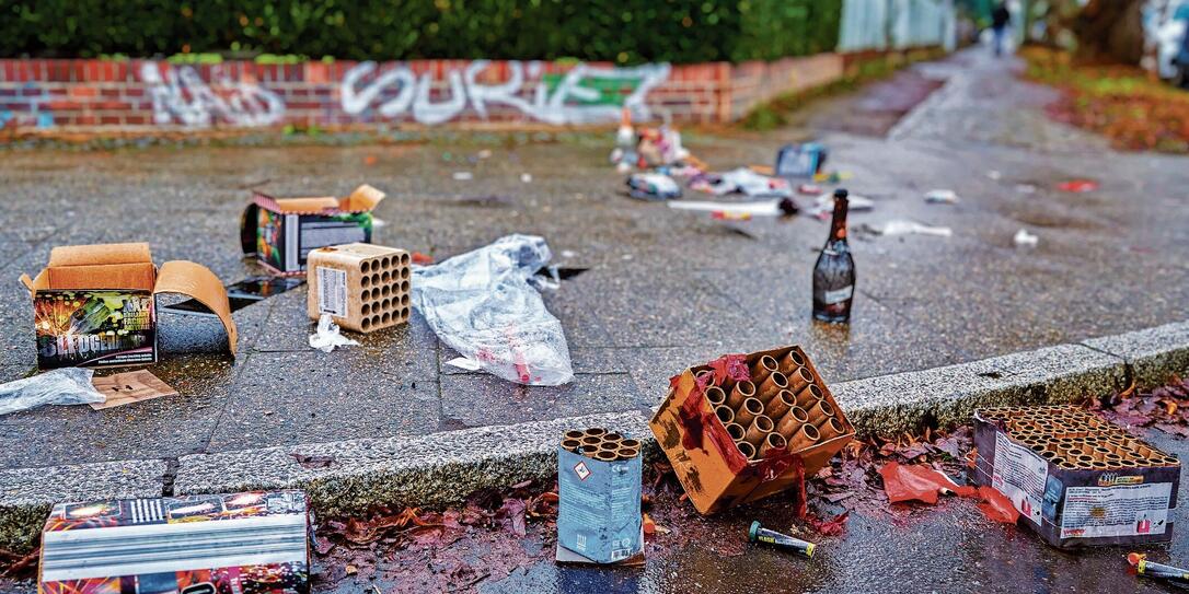 Remains of a New Year's Eve celebration on a sidewalk.