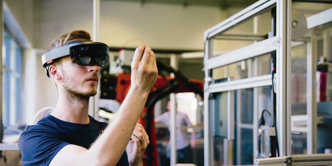 industry 4.0: Young engineer works with a head-mounted display