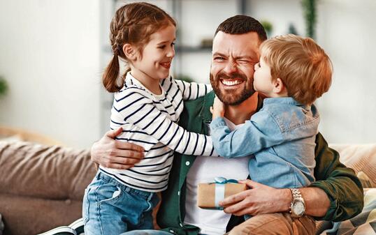 Happy father getting congratulations from kids