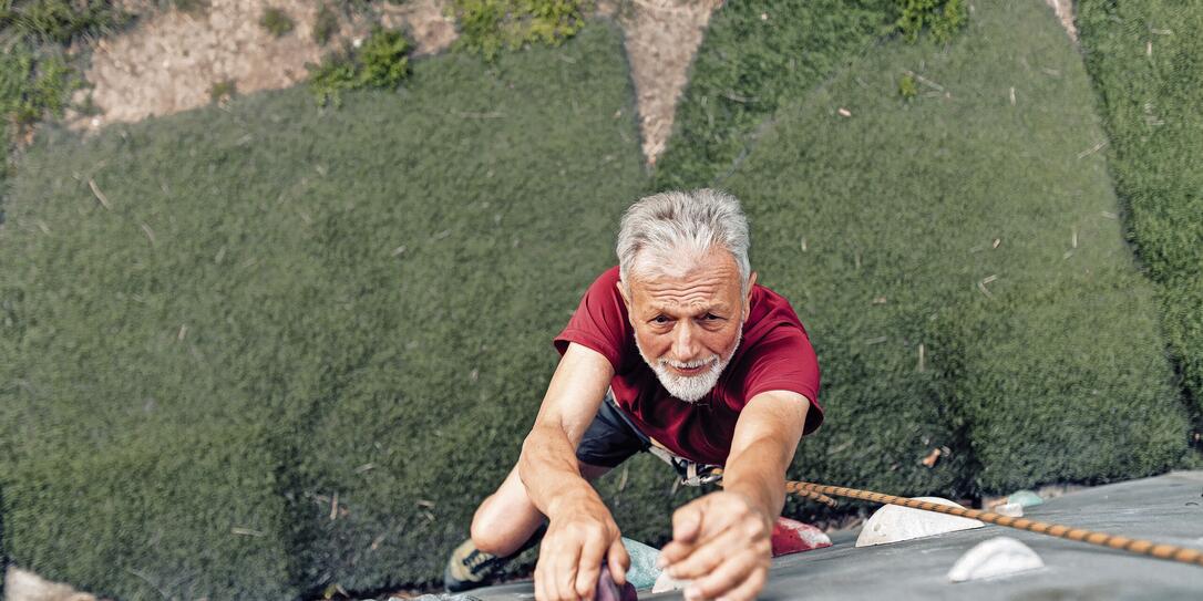 Senior sport climber enjoying on his training