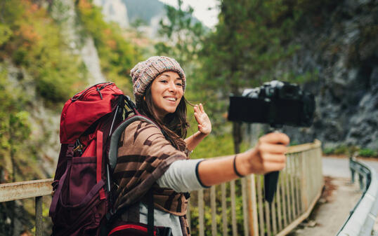 Live streaming in the nature. Female vlogger explorer.