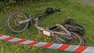 Electric bike overturned on the lawn, cyclist accident, area surrounded by safety tape